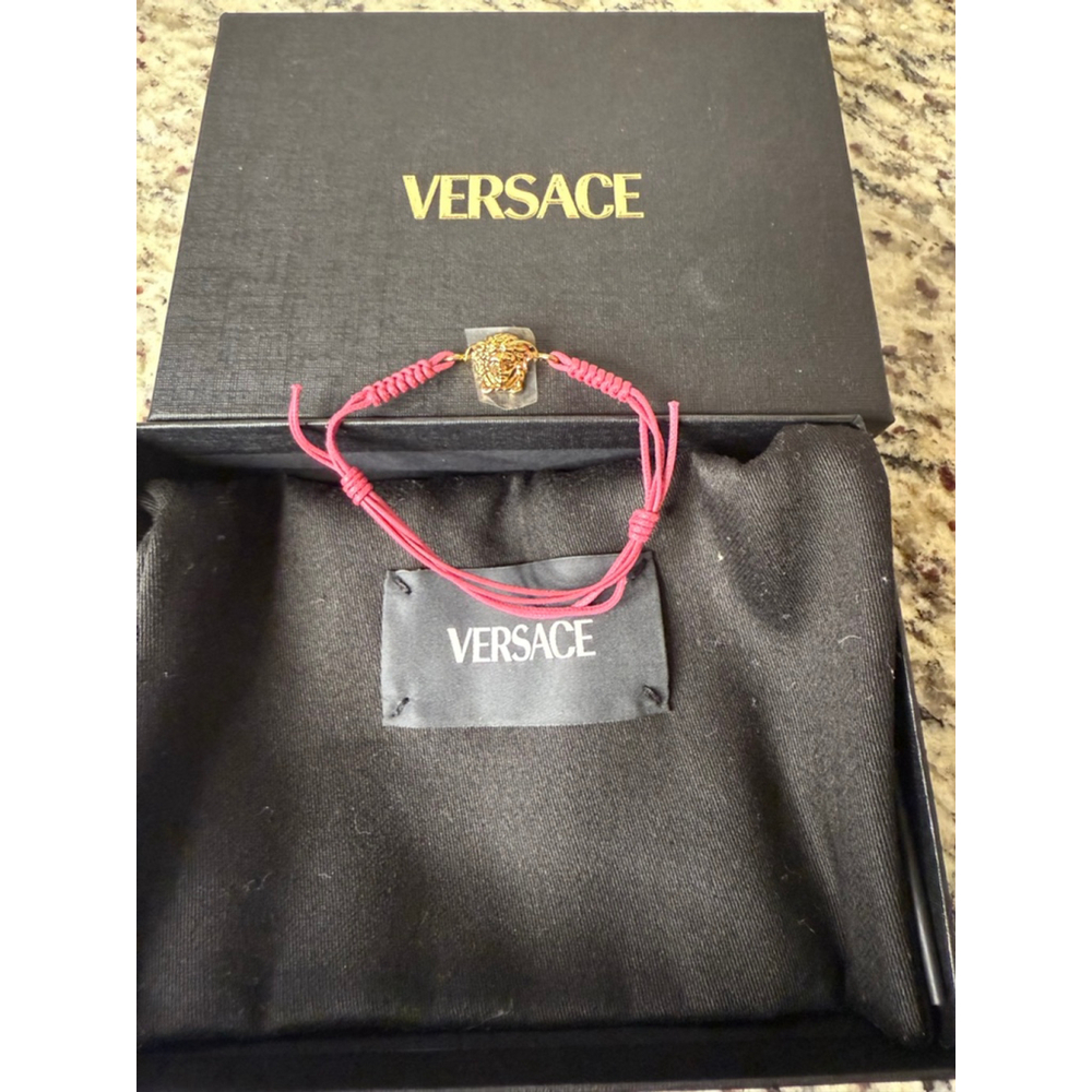 Women's Versace Gold Medusa Charm Bracelet on Pink Adjustable Cord
